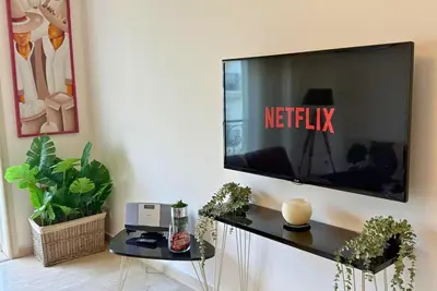 a living room with a television on a wall at Elegant & Chic 2 Bedrooms - Maarif in Casablanca