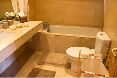 a bathroom with a toilet and a sink and a tub at Elegant & Chic 2 Bedrooms - Maarif in Casablanca