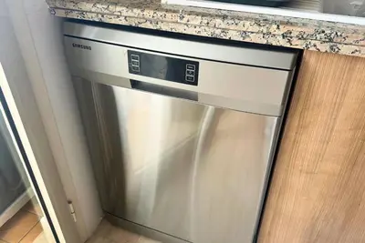 a dishwasher in a kitchen under a counter at Elegant & Chic 2 Bedrooms - Maarif in Casablanca