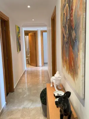 a room with a table with a painting on the wall at Elegant & Chic 2 Bedrooms - Maarif in Casablanca