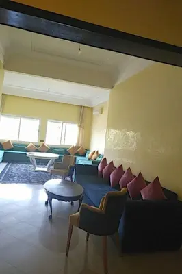 a living room with a couch and chairs and a table at Marina beach in Mohammedia