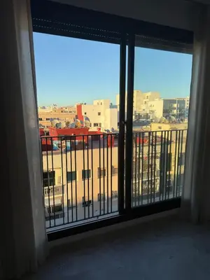 a room with a view of a city from a balcony at Metropoleparc luxury apparthotel in Casablanca