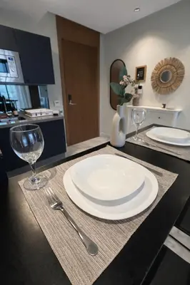a table with a plate and two wine glasses on it at Cedar Stays Appartement 1 chambre salon, parking, climatisation, Wifi, balcon in Casablanca
