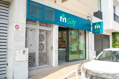a store with a car parked outside of it at Cedar Stays Appartement 1 chambre salon, parking, climatisation, Wifi, balcon in Casablanca