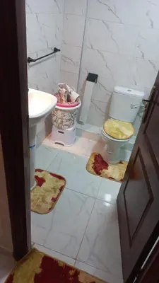 a bathroom with a sink and a toilet and towels at Appartement ville des roses in Mohammedia