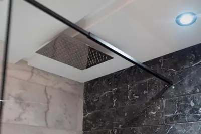 a ceiling light in a bathroom with a stone wall at Modern and cozy studio Close to CFC & Maarif in Casablanca