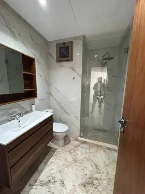 a bathroom with a shower and a sink and a toilet at Chez BÉA in Rabat