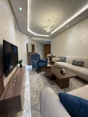 a living room with a couch and a tv at Chez BÉA in Rabat