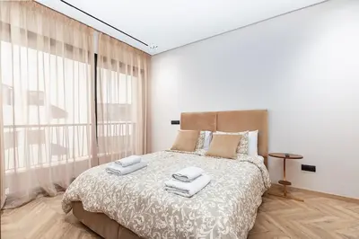 a bedroom with a large bed with towels on it at Modern & Calm Studio in Casablanca