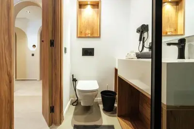 a bathroom with a white toilet and a sink at Résidence Pashmina in Maarif