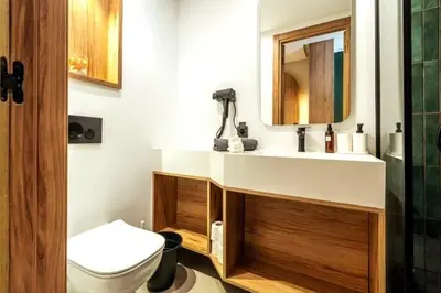 a bathroom with a sink and a toilet and a mirror at Résidence Pashmina in Maarif