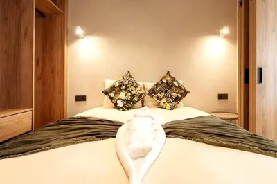 a bedroom with a bed with a towel on it at Résidence Pashmina in Maarif