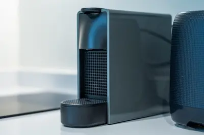a black speaker sitting next to a computer monitor at Résidence Pashmina in Maarif