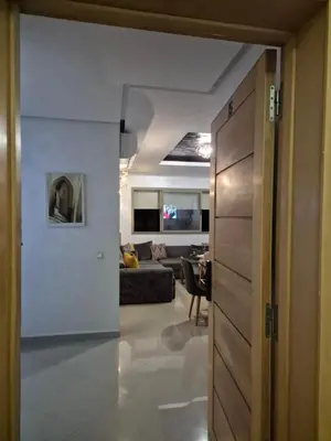 a hallway leading to a living room with a couch at Appartement Baraa Havre de sérénité entre mer et nature à tamaris in Tamaris