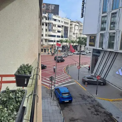 a blue car parked on a street in a city at Zen Stay Appart in Casablanca
