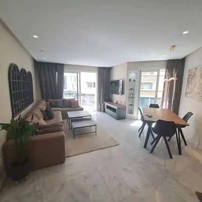a living room with a couch and a table at Zen Stay Appart in Casablanca