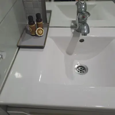 a white bathroom sink with two bottles on it at Zen Stay Appart in Casablanca