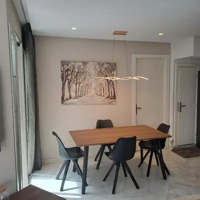 a dining room with a wooden table and chairs at Zen Stay Appart in Casablanca