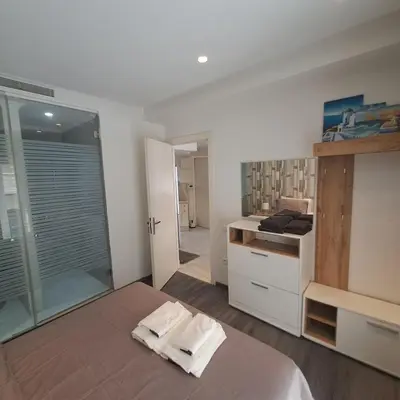 a bedroom with a bed and a sink and a mirror at Zen Stay Appart in Casablanca