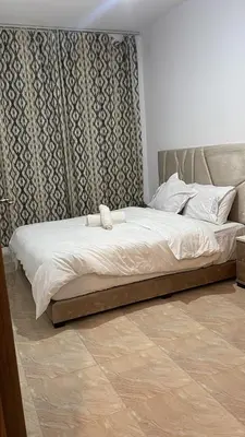 a bed in a bedroom with a headboard at High apartment in Oulad Hamida