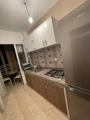 a kitchen with a stove and a counter top at High apartment in Oulad Hamida