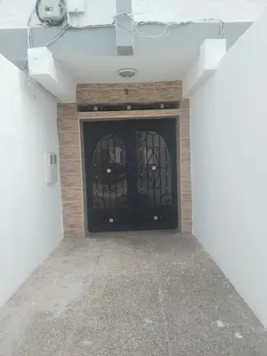 a black door in a room with a concrete floor at Sense house prime in Rabat