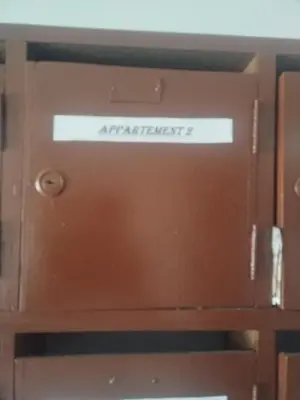 a brown door with a sign that reads attachment at Sense house prime in Rabat