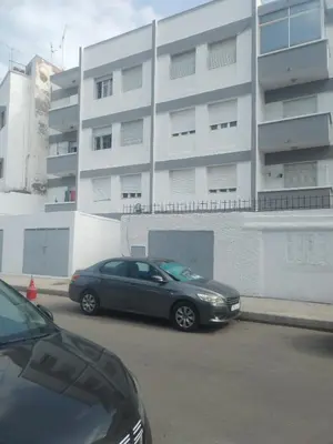 a black car parked in front of a building at Sense house prime in Rabat