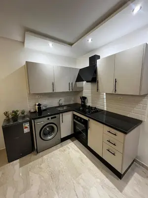 a kitchen with a washing machine and a washer at Studio moderne au centre ville avec wifi rapide in Maarif