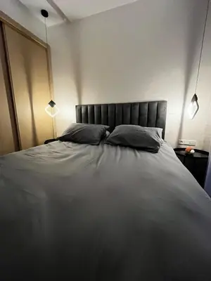 a bedroom with a large bed with two pillows at Studio moderne au centre ville avec wifi rapide in Maarif