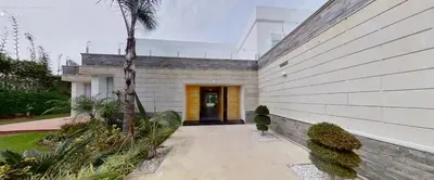 a house with a palm tree next to a building at Villa 9- luxurious 5 bedrooms villa in the heart of Ambassadors in Rabat