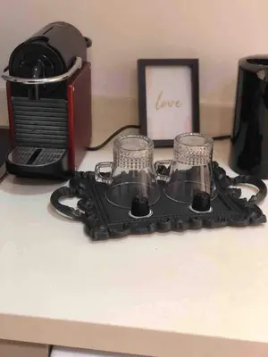 a desk with a coffee maker and two glasses at Cosy Maarif in Casablanca