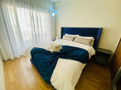 a bedroom with a teddy bear laying on a bed at Cosy Maarif in Casablanca