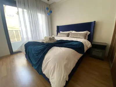 a bedroom with a bed with a teddy bear on it at Cosy Maarif in Casablanca