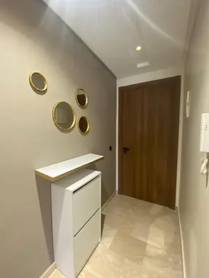 a bathroom with a white counter and gold mirrors on the wall at Cosy Maarif in Casablanca