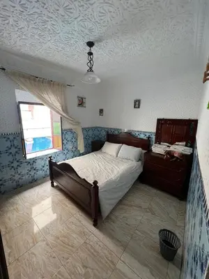 a bedroom with a large bed and a window at Hôte Nadia in Casablanca