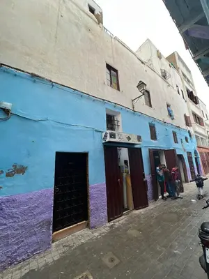 a blue building with people standing outside of it at Hôte Nadia in Casablanca