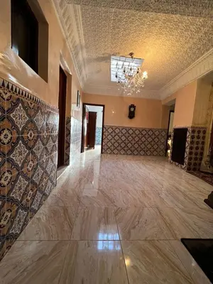 a large room with a marble floor and a chandelier at Hôte Nadia in Casablanca