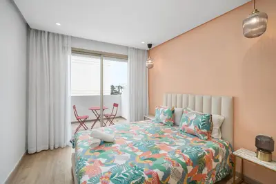 a bedroom with a bed and a table with chairs at Cozy studio on the Casablanca Ain Diab corniche in Casablanca