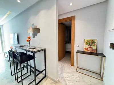 a dining room with a table and chairs at Cozy studio on the Casablanca Ain Diab corniche in Casablanca