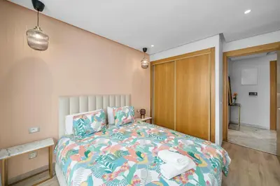 a bedroom with a bed with a colorful comforter at Cozy studio on the Casablanca Ain Diab corniche in Casablanca