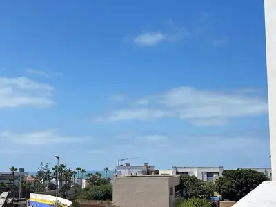 a blue sky with clouds over a city at Cozy studio on the Casablanca Ain Diab corniche in Casablanca
