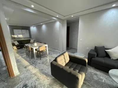 a living room with a couch and a table at Appartement neuf luxe OLM Aviation à Rabat in Rabat