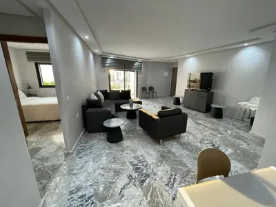 a living room with a couch and a table at Appartement neuf luxe OLM Aviation à Rabat in Rabat