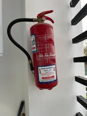 a fire extinguisher is hanging on a wall at Appartement neuf luxe OLM Aviation à Rabat in Rabat