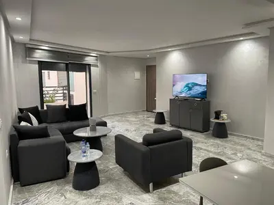 a living room with couches and a flat screen tv at Appartement neuf luxe OLM Aviation à Rabat in Rabat