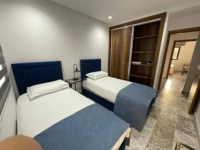a room with two beds in a room at Appartement neuf luxe OLM Aviation à Rabat in Rabat