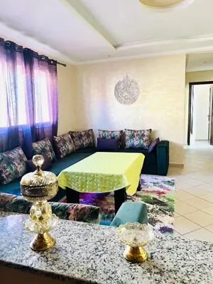 a living room with a couch and a table at Cozy & family apartment in Mohammedia in Mohammedia