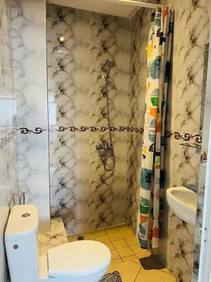 a bathroom with a toilet and a sink at Cozy & family apartment in Mohammedia in Mohammedia