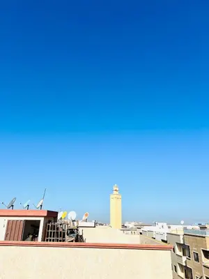 a view of a lighthouse from the roof of a building at Cozy & family apartment in Mohammedia in Mohammedia